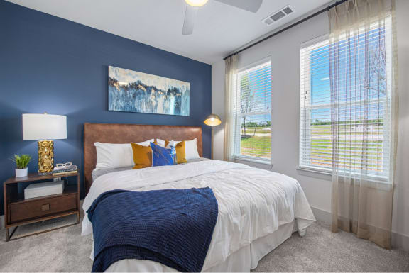 the residence with blue accent wall and large windows