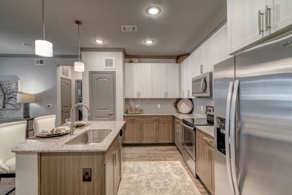 a kitchen with stainless steel appliances and white cabinets