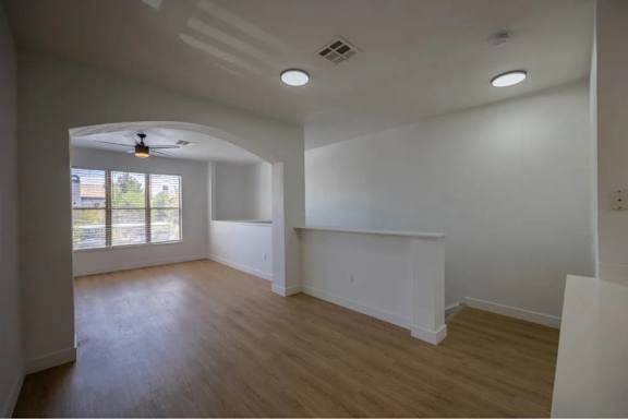 A room with a ceiling fan and a window.