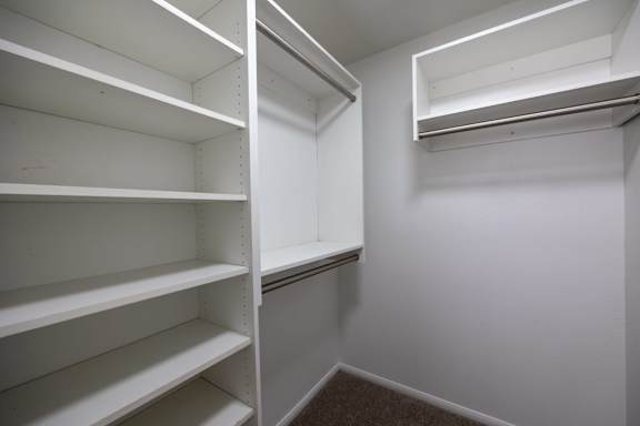 Empty white shelves in a room.