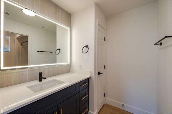 A bathroom with a sink and mirror.