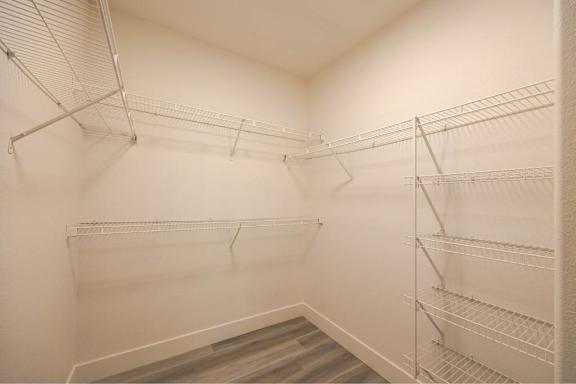 Empty shelves in a white pantry.
