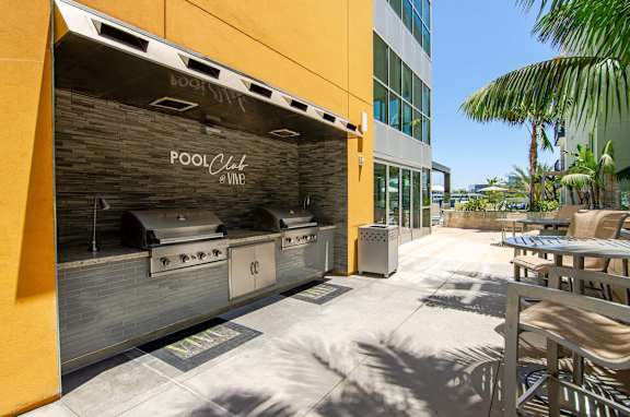 A pool club zone with a grill and seating area.