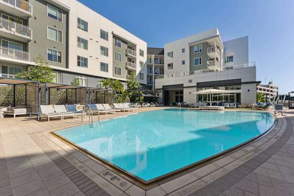 A large swimming pool in front of a modern building.