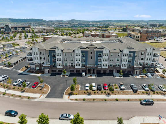 A large building with a parking lot in front of it.