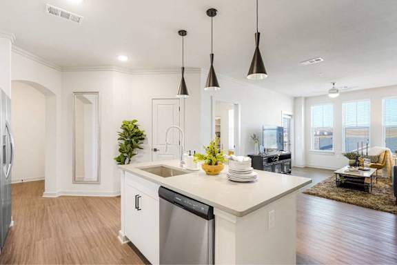 A kitchen with a white countertop and a dishwasher.
