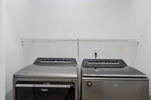 Two toaster ovens are sitting on a shelf.