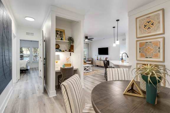 A modern living room with a wooden floor and a striped sofa.