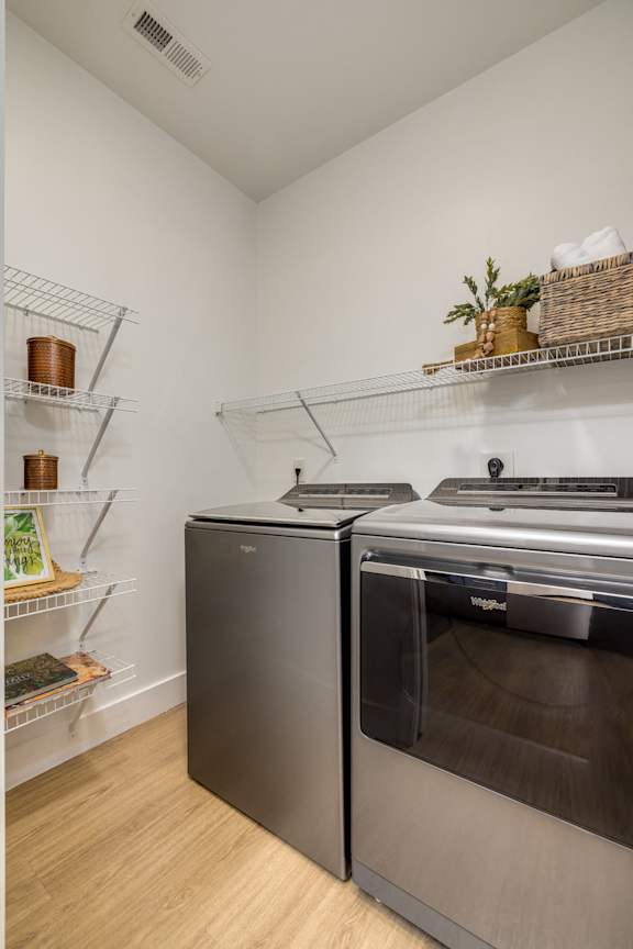 A kitchen with a stainless steel oven and a black dishwasher.