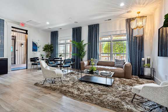 A living room with a brown rug and a brown couch.