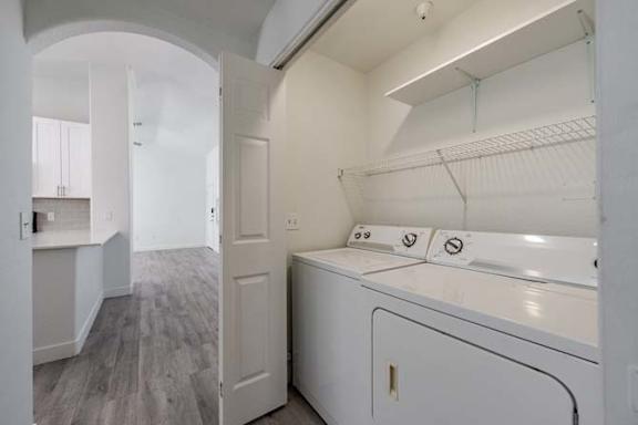A white laundry room with a washer and dryer.