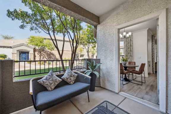 A patio with a couch and a table is shown.