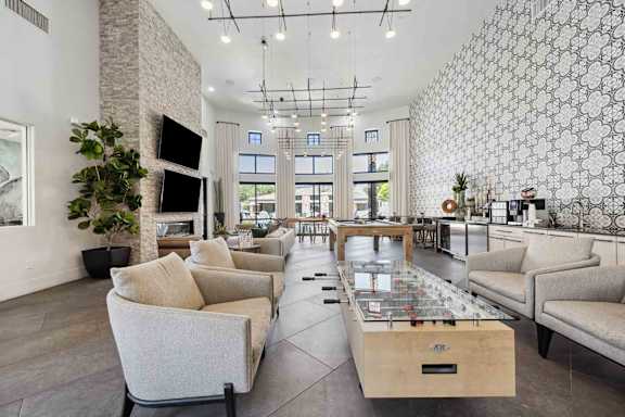 A modern living room with a stone fireplace and a large patterned wallpaper.