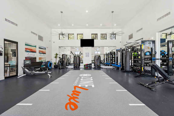 A gym with a variety of equipment and a sign that says "AM/PM".
