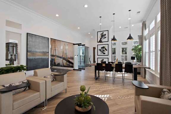 A living room with a large couch, a coffee table, and a dining table with chairs.