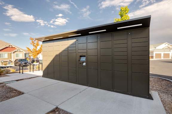 A black building with a tree in front of it.