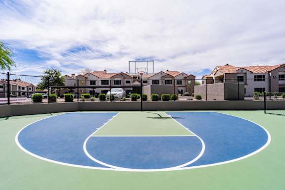 A basketball court in the middle of a residential area.