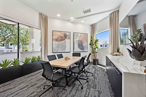 A conference room with a long table and chairs.