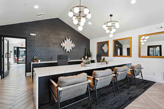A modern kitchen with a long island and chairs.