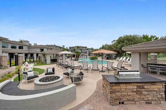 A patio area with a fire pit and seating area.