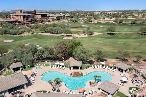 A large resort with a pool and golf course.