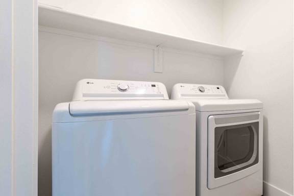 Two white appliances, a dishwasher and an oven, are installed in a wall.