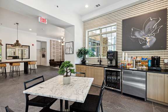 A modern kitchen with a marble table and a bamboo wall.