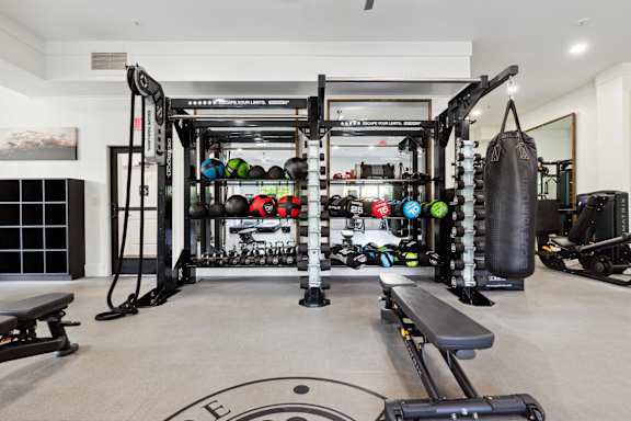 A well-equipped home gym with a variety of exercise equipment.