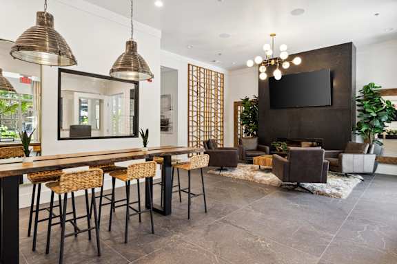 A modern living room with a bar area and a television.