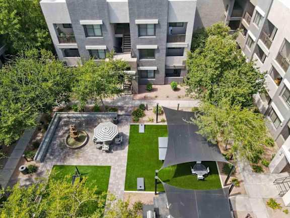 A modern building with a courtyard and a fountain.
