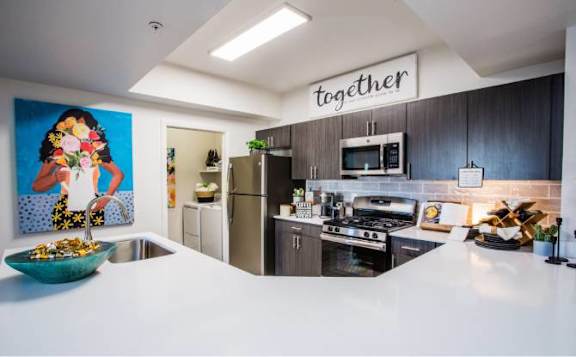 A kitchen with a bowl of food on the counter.