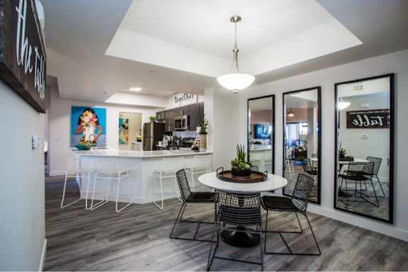 A modern dining room with a round table and chairs.