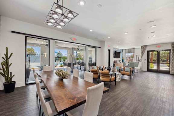 A dining room with a wooden table and chairs.