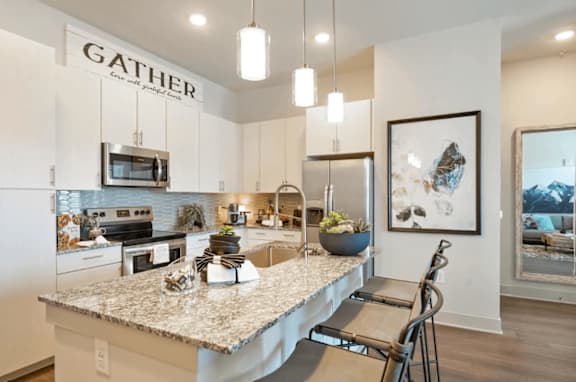 an open kitchen with a granite counter top