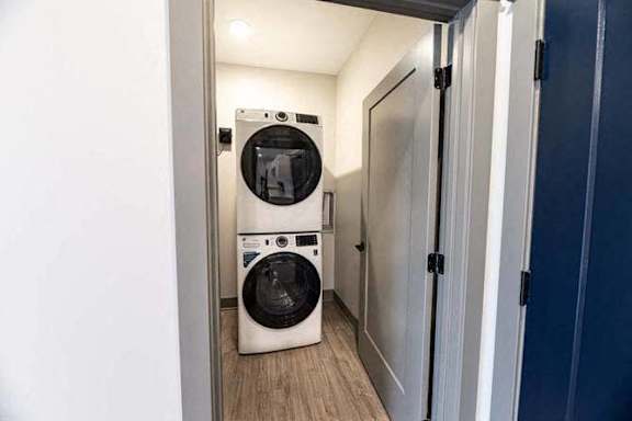 A washing machine and dryer in a small laundry room.