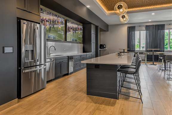 A modern kitchen with a large island and stainless steel appliances.