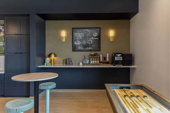 A modern cafe interior with a wooden table and a bar counter.