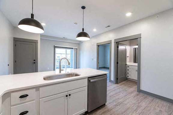 A kitchen with a sink and cabinets.