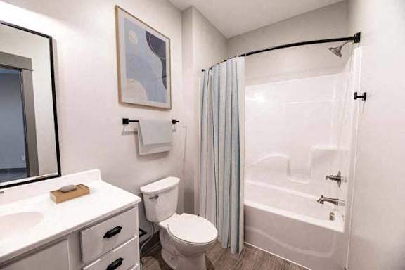A white toilet sits next to a sink in a small bathroom.