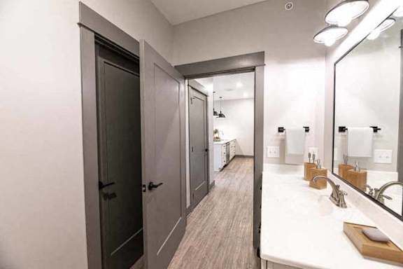 A bathroom with a white counter and a mirror.
