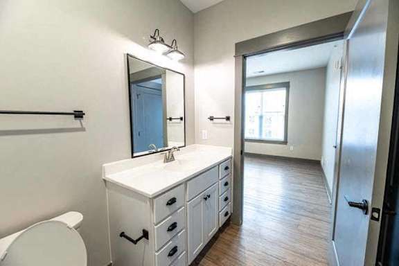A bathroom with a white counter and a mirror.