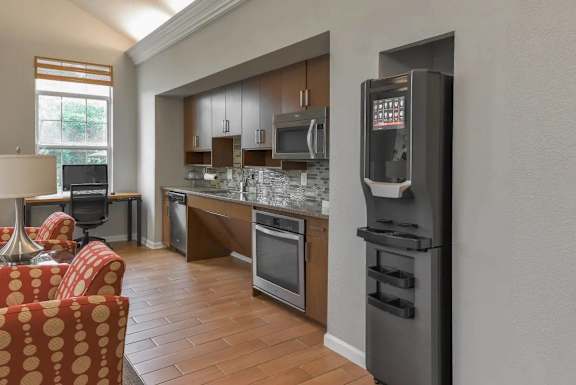A modern kitchen with a refrigerator on the right side.