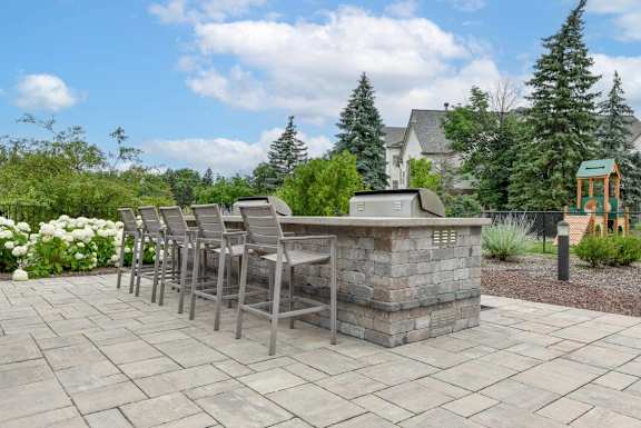 A patio with a stone table and chairs.
