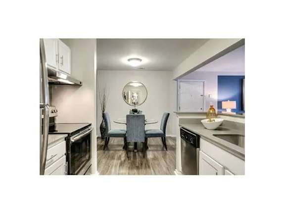 A modern kitchen with a dining table and chairs.