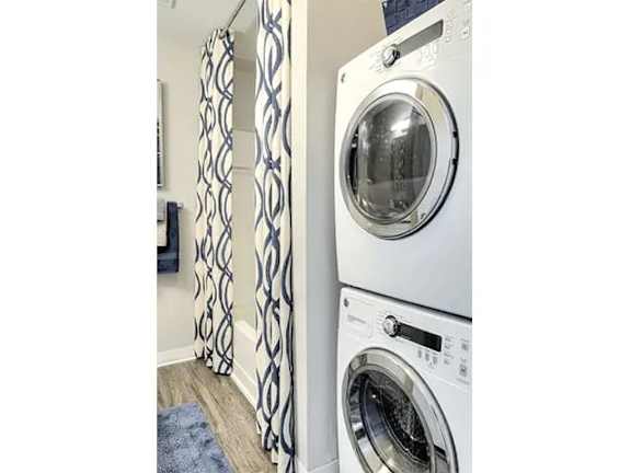 A white washing machine and dryer in a laundry room.