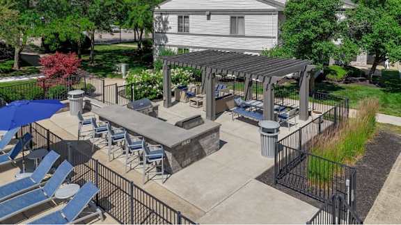 A patio with a table and chairs under a roof.
