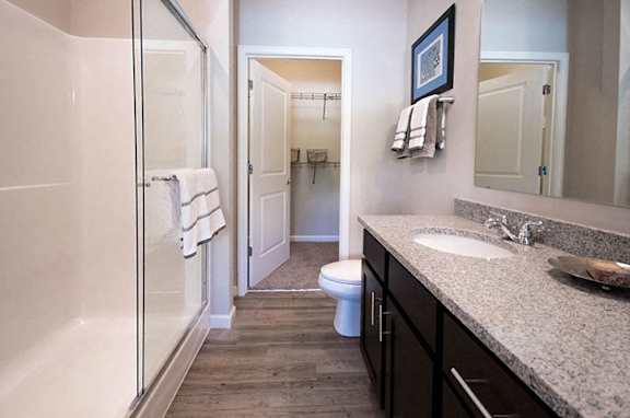 A bathroom with a toilet, sink, and shower.