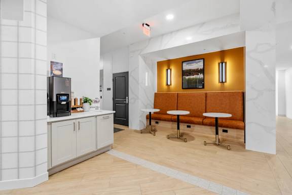 A kitchen with a counter and a bench.