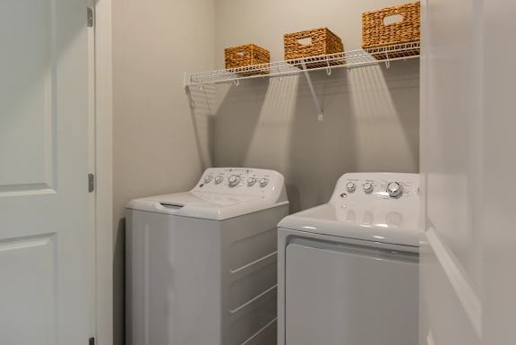Two front loading washing machines in a laundry room.