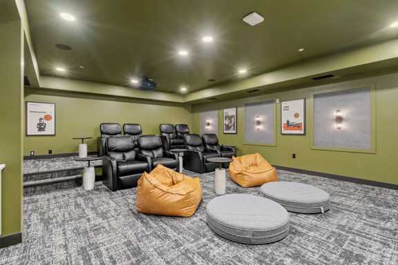 A room with a carpeted floor and a row of chairs.
